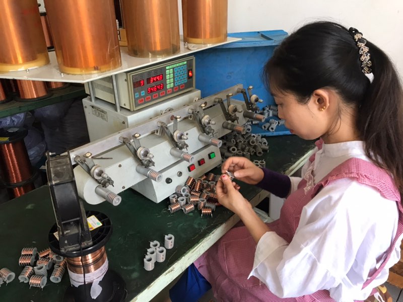 A worker making electronic components at a Tianchang factory