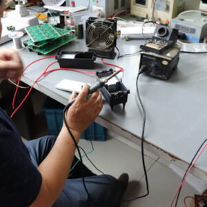 Technician assembling a custom high-voltage power supply in Tianchang